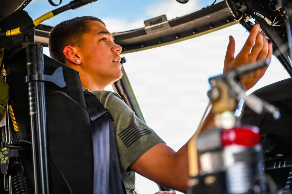 Young man in the cockpit of an Idaho Army National Guard helicopter, photo by Rusty Rehl