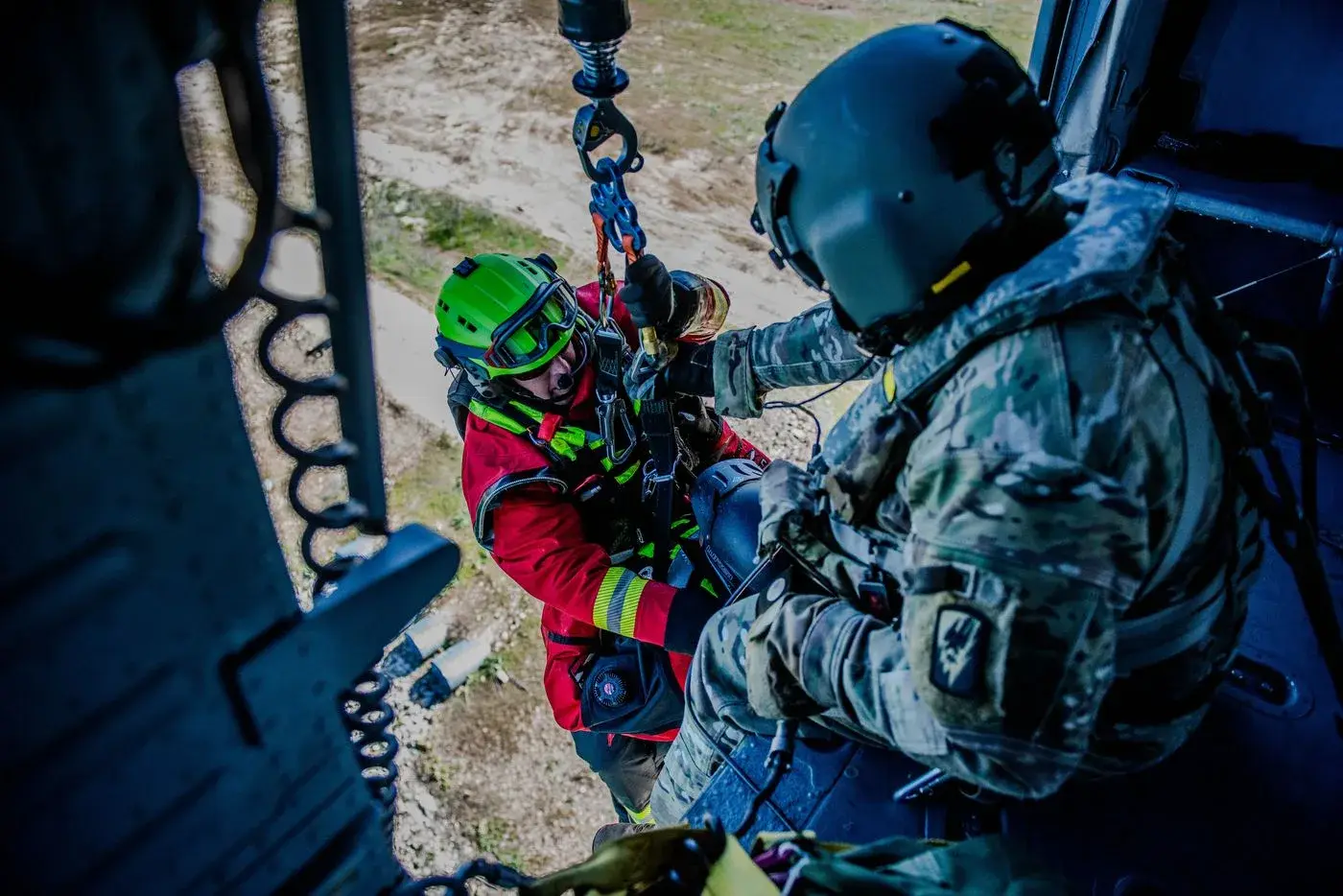 Idaho Army National Guard Black Hawk crew chief brings a rescuer aboard on the hoist, photo by Rusty Rehl