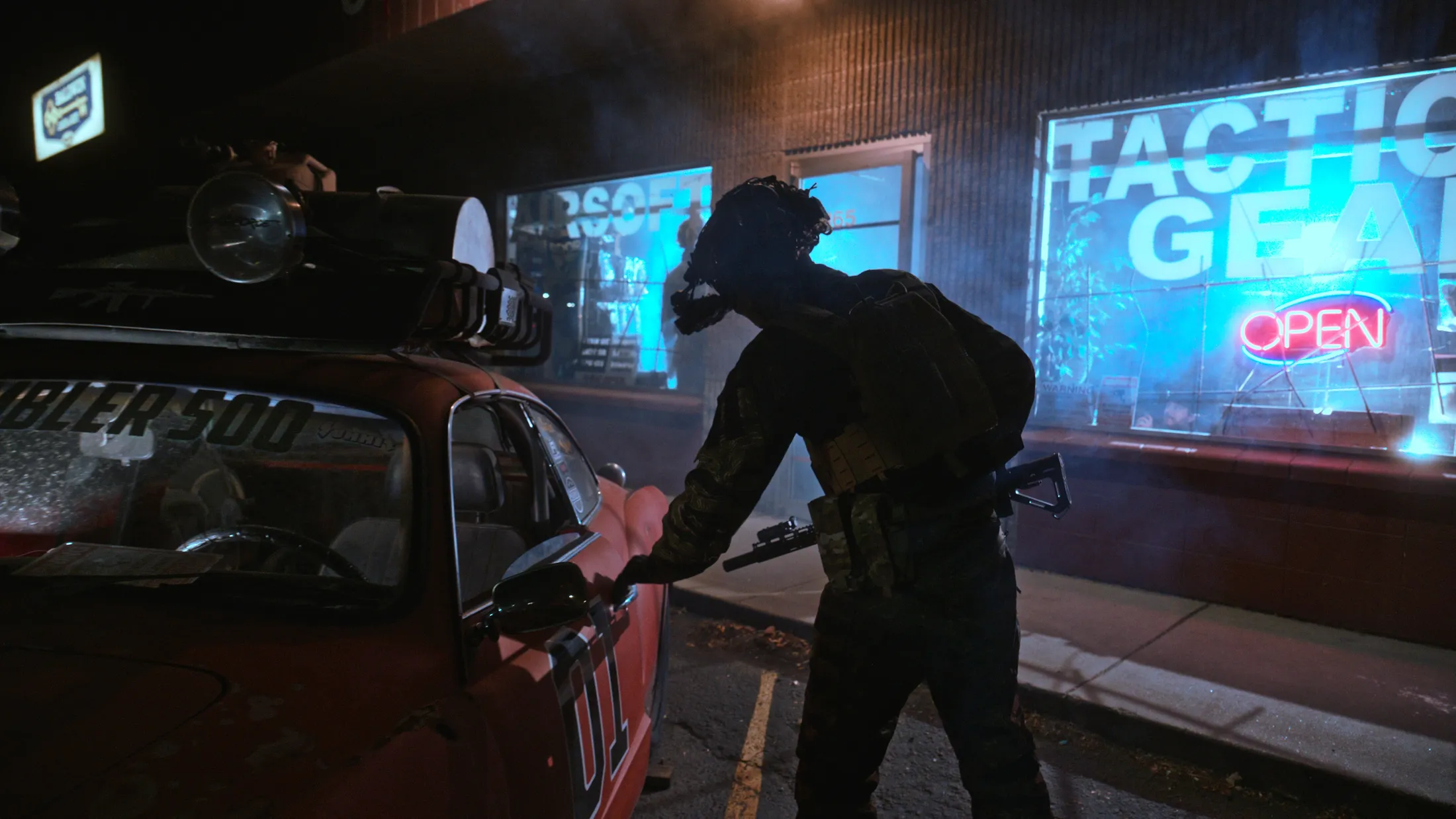Commando with night-vision goggles reaching for a battered red car outside an airsoft and tactical gear shop lit cyan with a red open sign, still from Rusty Rehl's ad for Combat Sport Supply