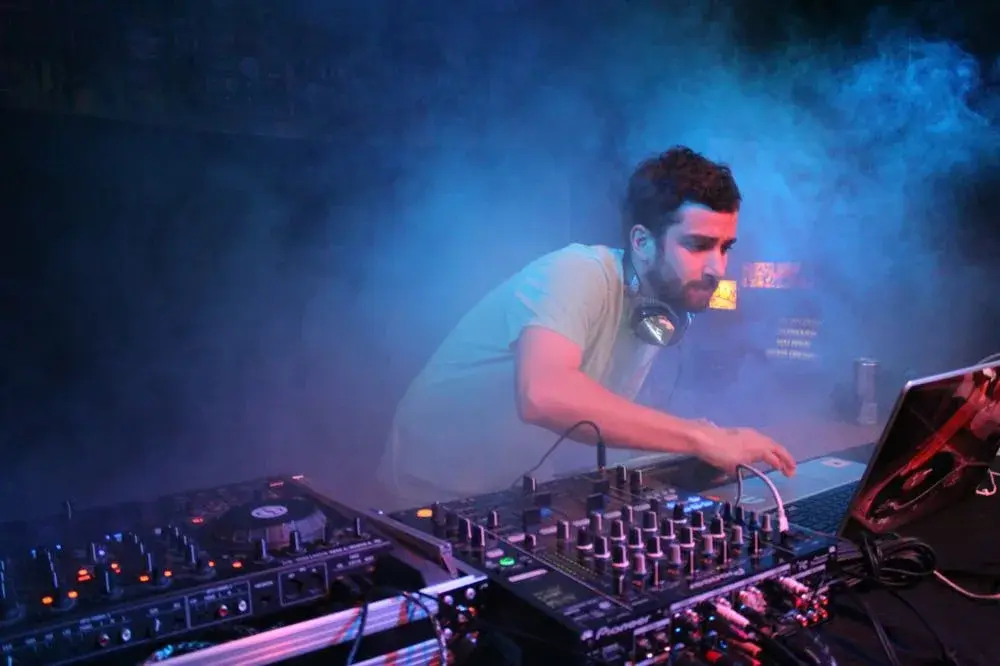DJ at the mixer in blue smoke at a Boise, Idaho show, concert photo by Rusty Rehl